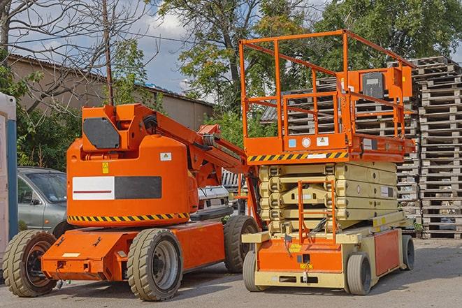 forklift moving heavy loads in busy warehouse setting in Byfield