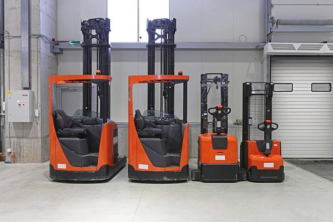 two forklifts parked in a warehouse